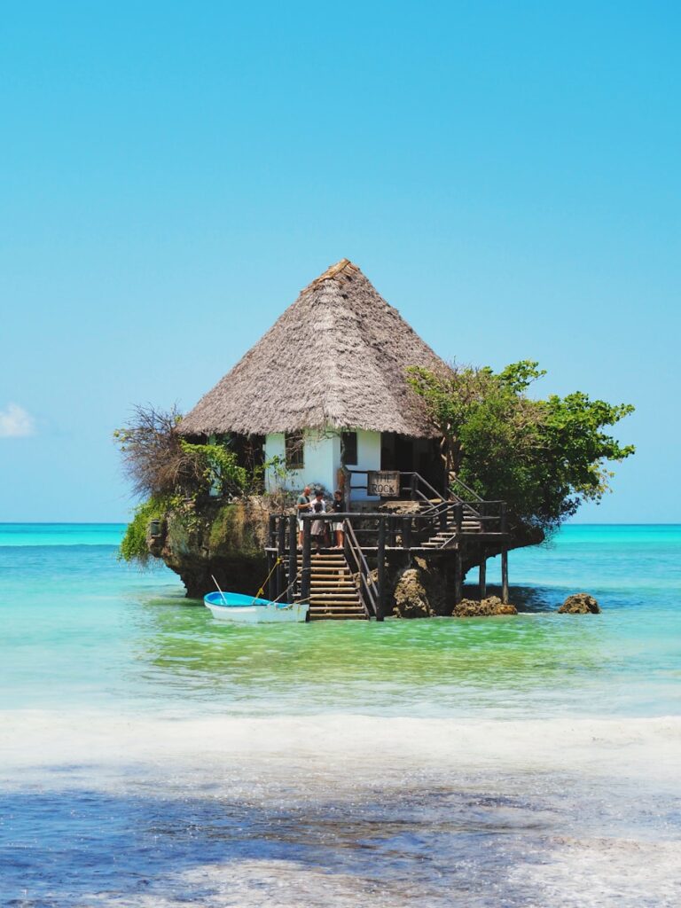 A hut on a small island in the middle of the ocean